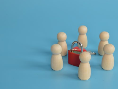 Wooden figure of people standing around the padlock. The concept of security and personal data